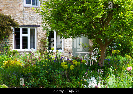 A pretty English country front garden in the Cotswolds in spring or early summer Stock Photo