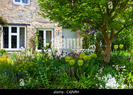 A pretty English country front garden in the Cotswolds in spring or early summer Stock Photo