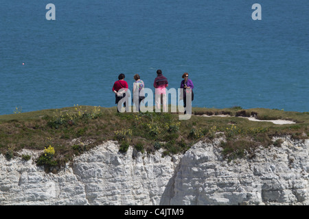 Walkers on chalk cliffs near Old Harry Rocks on the Dorset coast. Isle of Purbeck, Dorset, UK. Stock Photo