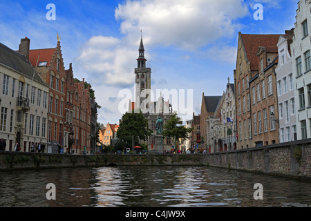 Jan Van Eyck Square with the Poortersloge and the statue of Jan Van Eyck. View from the Spieglerei canal, Stock Photo