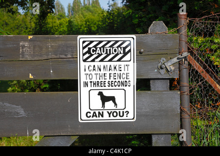 Dog warning sign on gate to private property - I can make it to the fence in three seconds, can you? Stock Photo