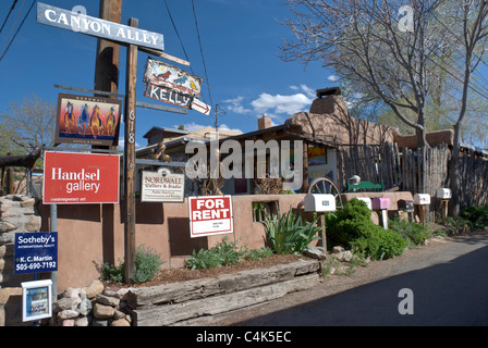 A portion of Canyon Road in Santa Fe is lined with signs and mailboxes. Stock Photo