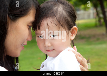 embarrassed little girl and her mother Stock Photo