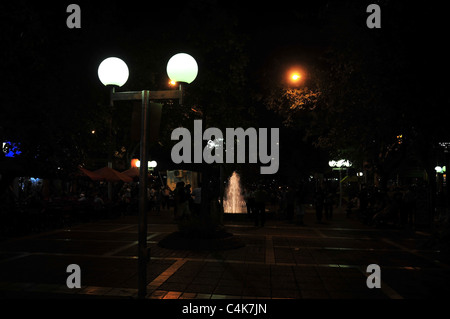 Black sky night-time urban pedestrian street view of ornamental lamps and water fountain, Paseo Sarmiento, Mendoza, Argentina Stock Photo