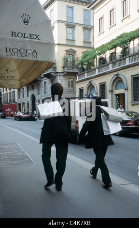 Men with shopping bags on Via Montenapoleone, Milan, Italy. Stock Photo