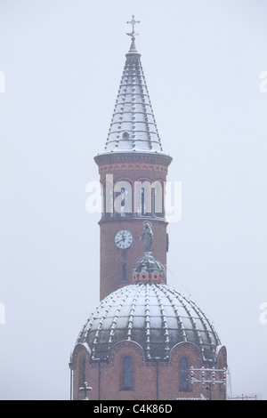Vertical oriented image of church domes covered with snow in Alba, Italy. Stock Photo