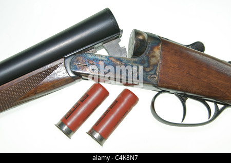 A 12 gauge bore shotgun. This is an AYA No 4 Boxlock side-by-side double barreled gun 'broken' to insert cartridges. Stock Photo