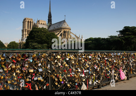 Love locks on Pont de L'Archeveque in Paris, France with Notre Dame Stock Photo