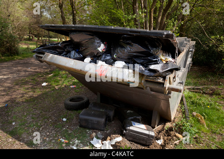 over full rubbish skip in countryside location Stock Photo