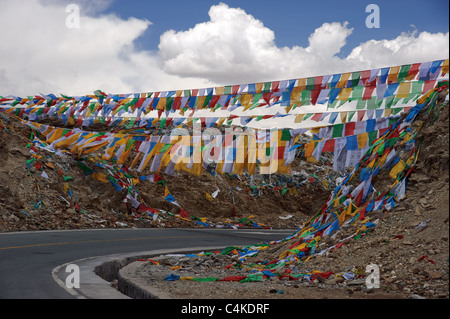 Colorful Tibetan prayer flags hanging across the road Stock Photo