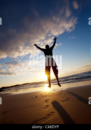 Jumping boy on beach Stock Photo