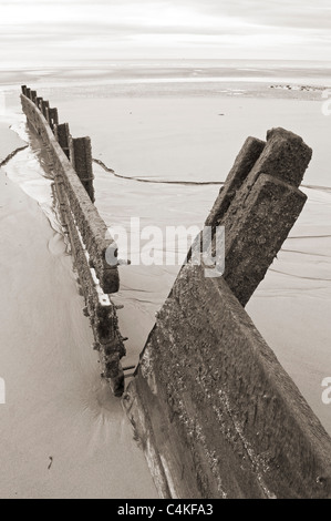 Old broken breakwater on beach showing severe coastal erosion ...