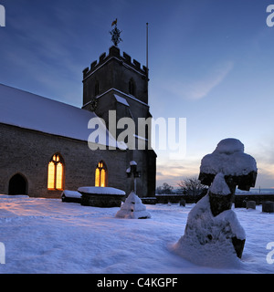 St Dunstan's church in Baltonsborough, Somerset, at twilight on a snowy winter evening. Stock Photo