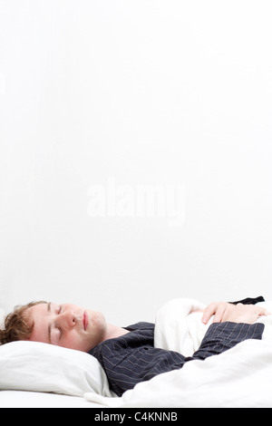 A man sleeping in his pyjamas Stock Photo