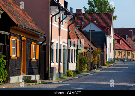 Traditional wooden houses in cobbled street of the Hanseatic town Visby, Gotland, Sweden Stock Photo