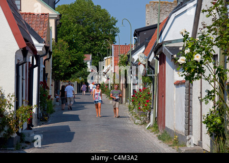 Traditional houses in cobbled street of the Hanseatic town Visby, Gotland, Sweden Stock Photo