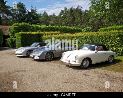 three different convertible Porsches parked in a row. front to back a 356, a 911, and a Boxster. Stock Photo