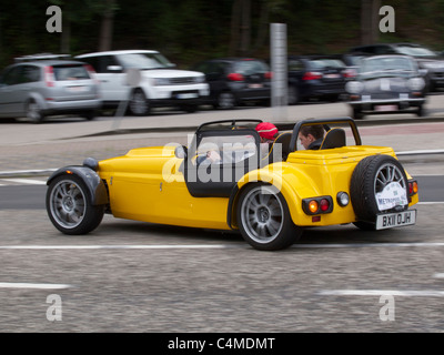 Yellow Westfield Super Seven speeding away at the start of a classic car rallye in Belgium Stock Photo