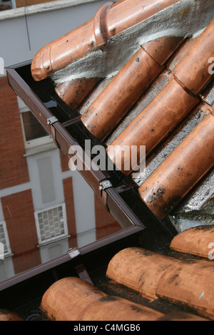 rain falling on wet terracotta roof tiles of house home property Stock Photo