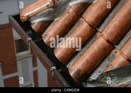 rain falling on wet terracotta roof tiles of house home property Stock Photo