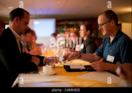 Small business owners meeting in a 'speed dating' networking event, designed to enable them to make new local contacts UK Stock Photo