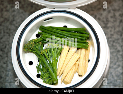 Vegetables in electric steamer ready to cook, London Stock Photo
