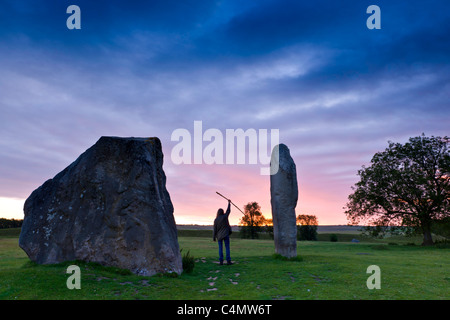 Greeting the sun - A druid greets the sun between the Avebury stones. Stock Photo