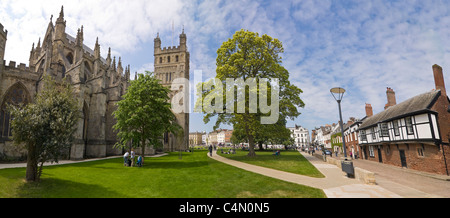 Horizontal panoramic view of the North Tower of Exeter Cathedral and the Clergy House on Cathedral Square on a sunny day. Stock Photo