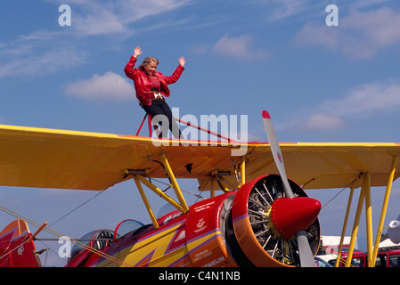 Wingwalker (Teresa Stokes) wingwalking on Gene Soucy's Biplane 'Showcat' at Abbotsford Airshow, BC, British Columbia, Canada Stock Photo