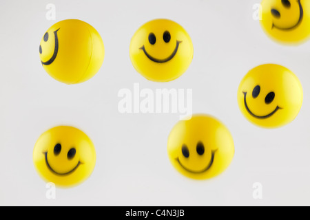 Bouncing yellow smiley face balls Stock Photo