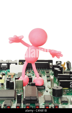 Rubber figurine playing on electronic circuit board with copy space Stock Photo