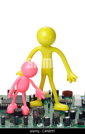 Colorful rubber figurines on computer circuit board - Information Technology Education Stock Photo