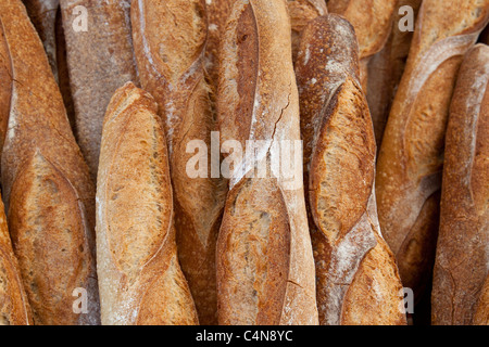 Freshly-baked French bread baguettes on sale at food market in Bordeaux region of France Stock Photo