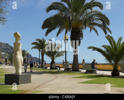 People tourists visitors walking along the promenade on the seafront Funchal Madeira Portugal EU Europe Stock Photo