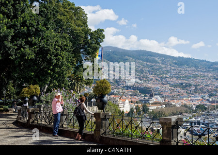 Visitors tourists people looking towards the City from the garden of the Governor's residence Funchal Madeira Portugal EU Europe Stock Photo