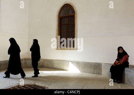 Three young women at Jameh Mosque (Friday mosque) in Yazd, Iran Stock Photo