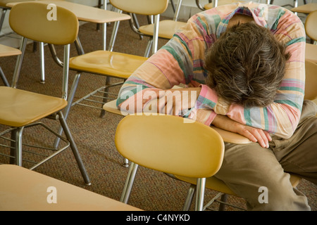 Man sleeping in a college classroom Stock Photo