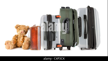 Idea for family travel with a row of different types of suitcase with a teddy bear at the end Stock Photo