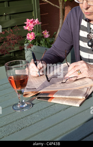 OLDER WOMAN READING FINANCIAL TIMES Stock Photo