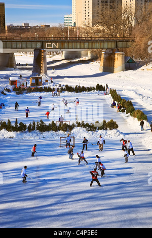 Ice hockey players on frozen Assiniboine River, The Forks, Winnipeg, Manitoba, Canada Stock Photo