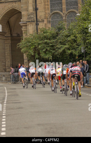 Professional cyclists competing in town centre road race Stock Photo