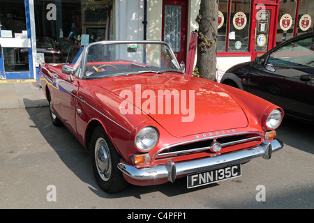 A restored 1965 red Sunbeam Tiger V8 parked on the roadside in Royal Wootton Bassett, Wiltshire, England, UK. Stock Photo