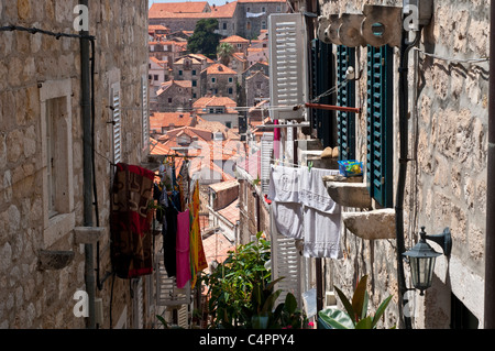 Narrow street with washing and rooftops in the background, Dubrovnik, Croatia Stock Photo