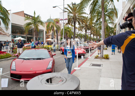 Japanese tourists taking snapshots on at the 2011 Rodeo Drive Concours Stock Photo