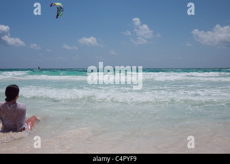 Woman watches kite boarder Stock Photo