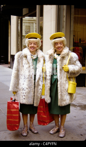 two famous  identical  San francisco twin wearing identical outfits pose while shopping on Union Street Stock Photo