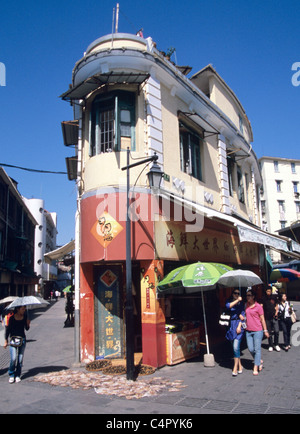 Gulangyu, China shoppers walk past shop with dried seafood in the old  island port city on hot summer afternoon. © Bob Kreisel Stock Photo