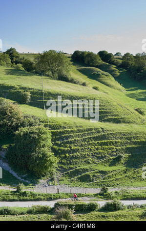 Chalk downs at Heddington, Wiltshire, England, United Kingdom, Great Britain, UK ,GB with cyclist in red shirt Stock Photo