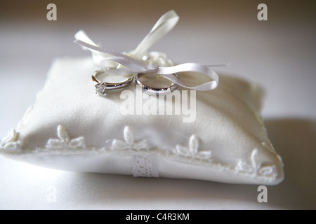 Pair of wedding rings on pillow Stock Photo