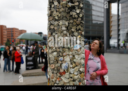 Chewing gum covers graffiti on a segment of the Berlin Wall placed as a monument at Potsdamer Platz in Berlin, Germany Stock Photo